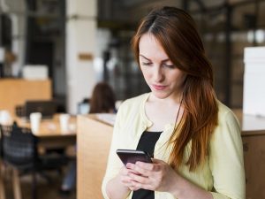 Mujer revisando catálogo de productos para comprar por WhatsApp Business